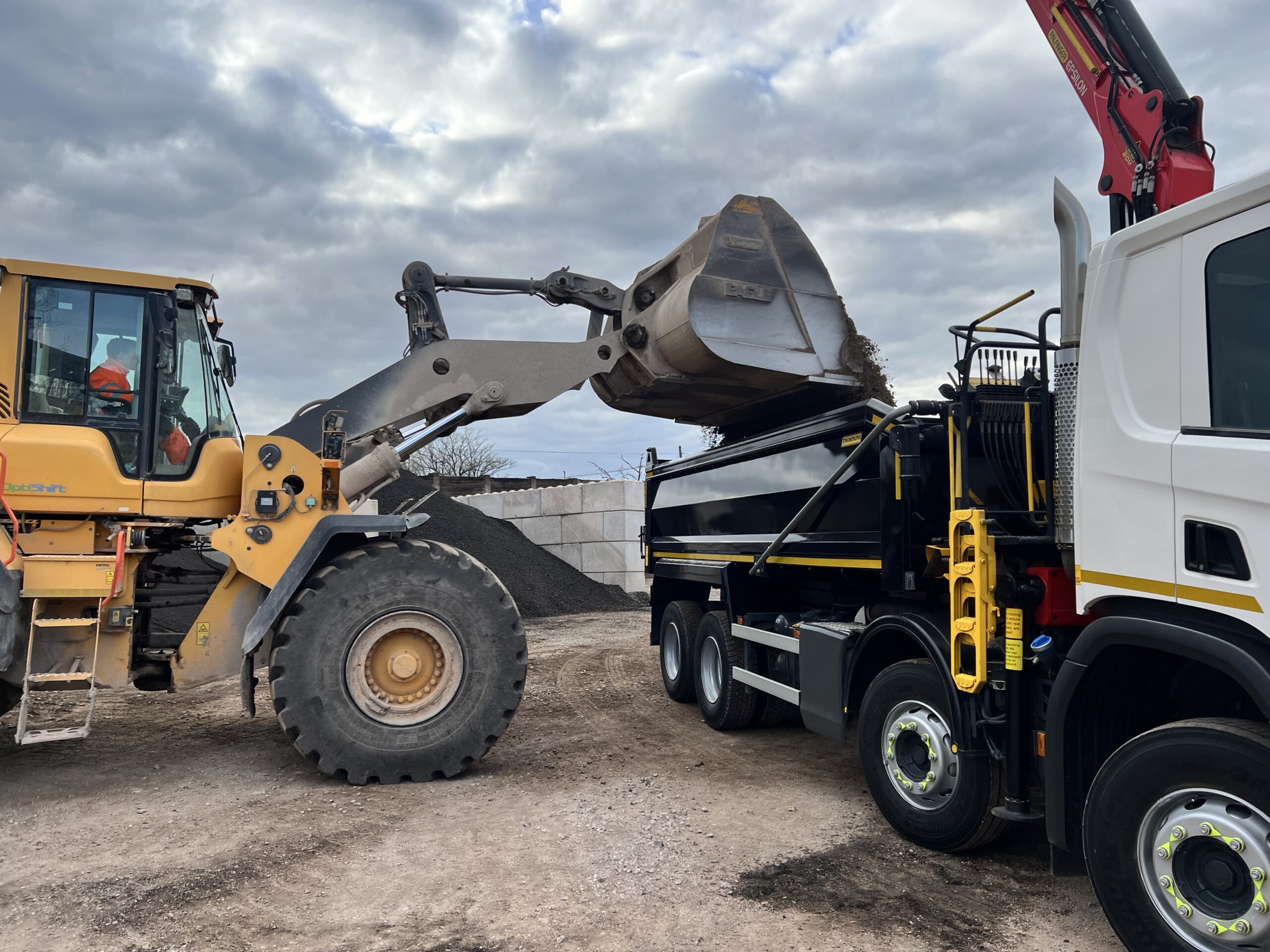 AFD Transport grab lorry being loaded on a coastal building site